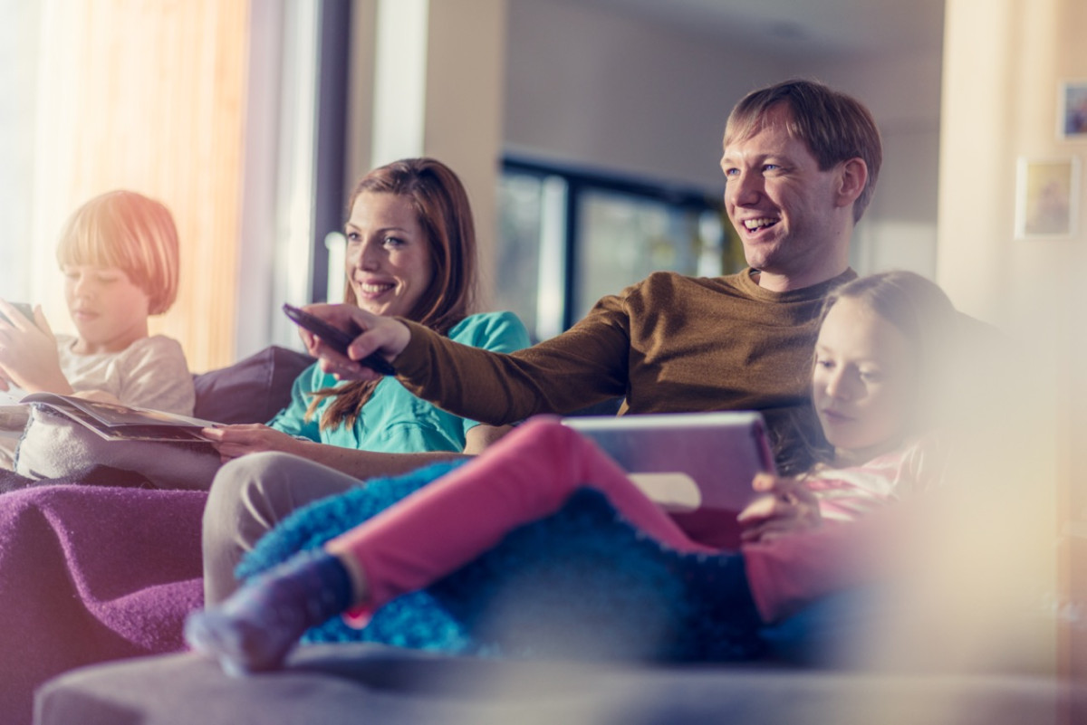 Family using multiple devices with full fibre broadband